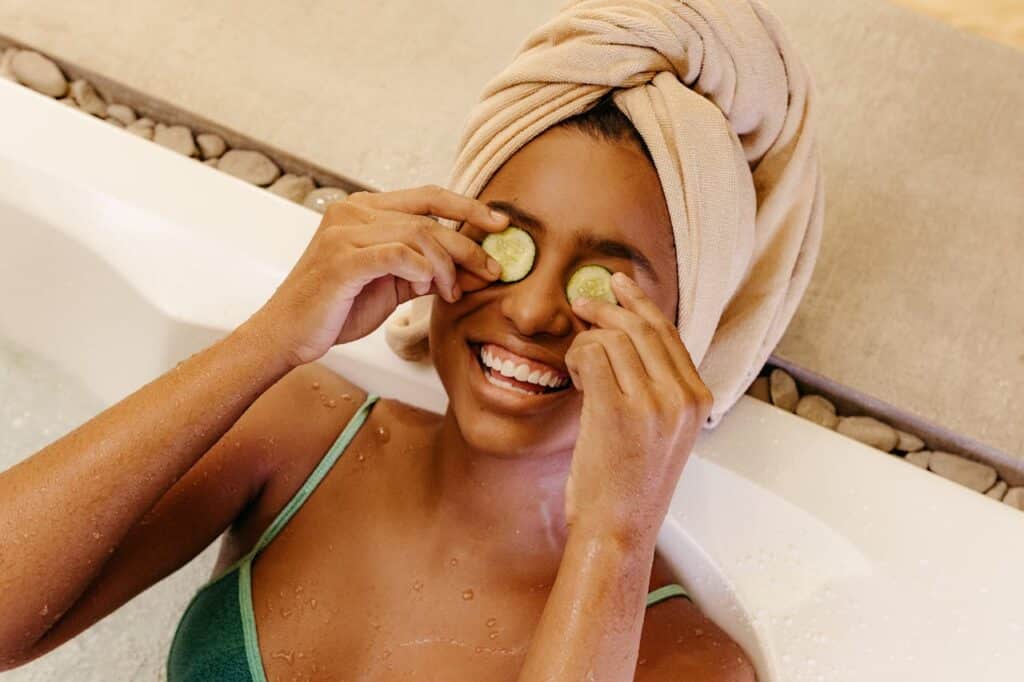 pexels-photo-19666205 Woman enjoying a spa bath with cucumber slices on eyes, embracing relaxation.