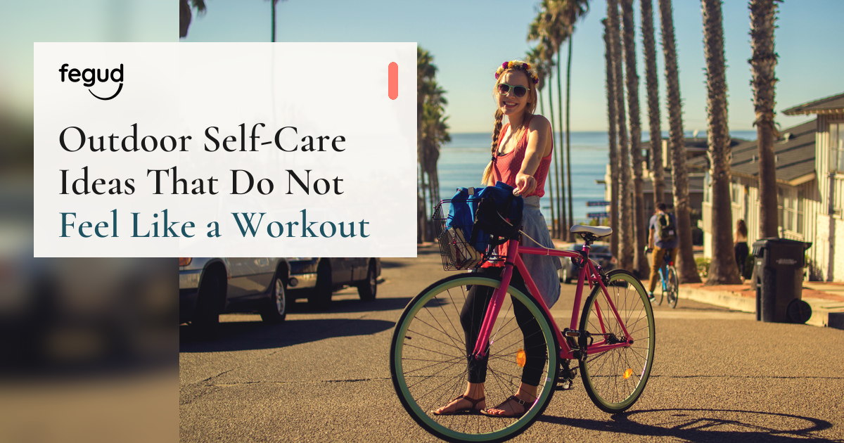 Woman with a bicycle by the sea considering outdoor self-care ideas