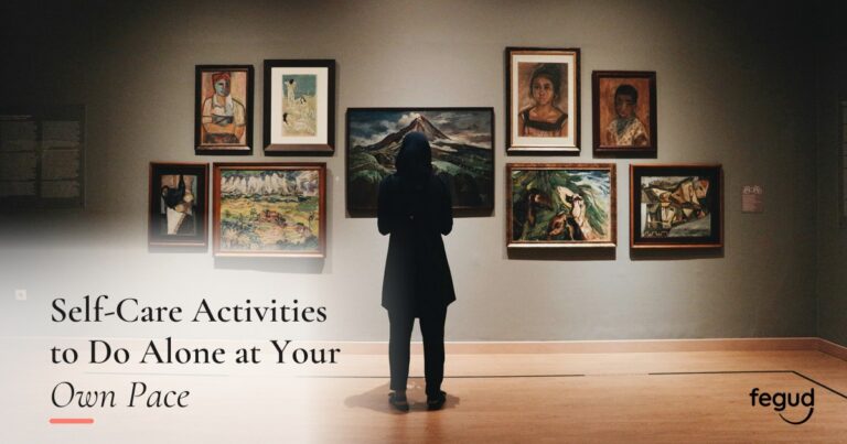 Person viewing artwork while choosing self-care activities to do alone