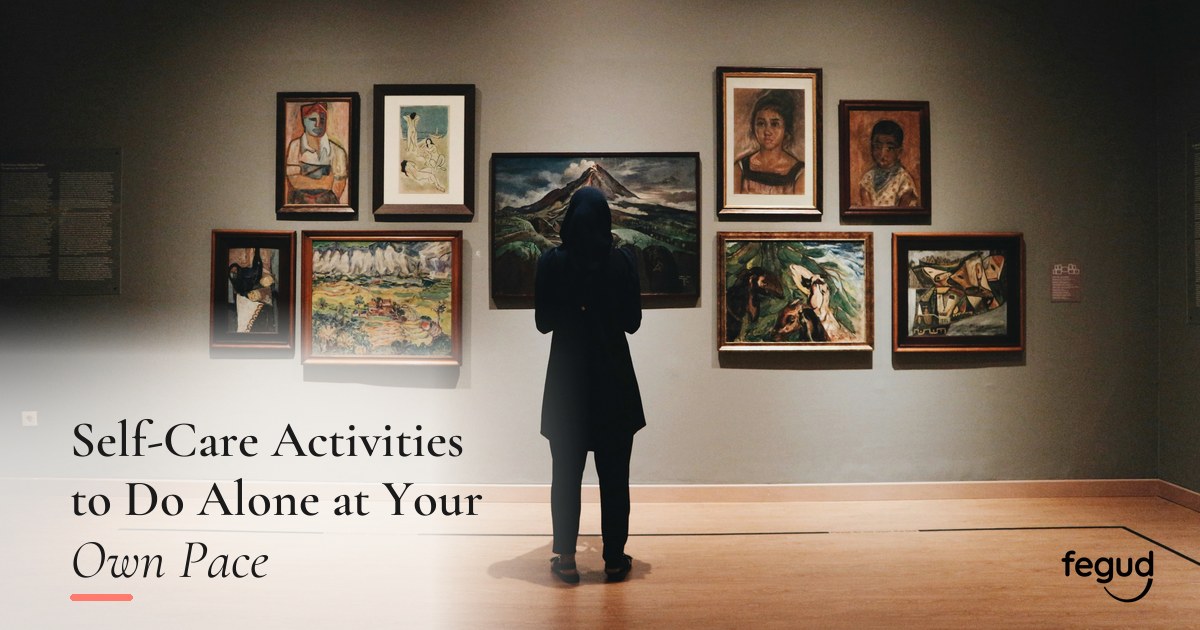 Person viewing artwork while choosing self-care activities to do alone