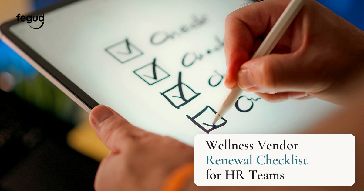Hands using a wellness vendor renewal checklist on a tablet